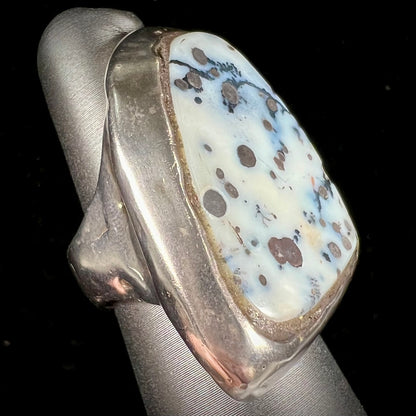 A bezel set ring handmade in sterling silver with a white dendritic agate stone.