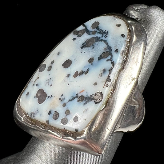 A bezel set ring handmade in sterling silver with a white dendritic agate stone.