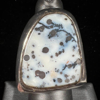 A bezel set ring handmade in sterling silver with a white dendritic agate stone.