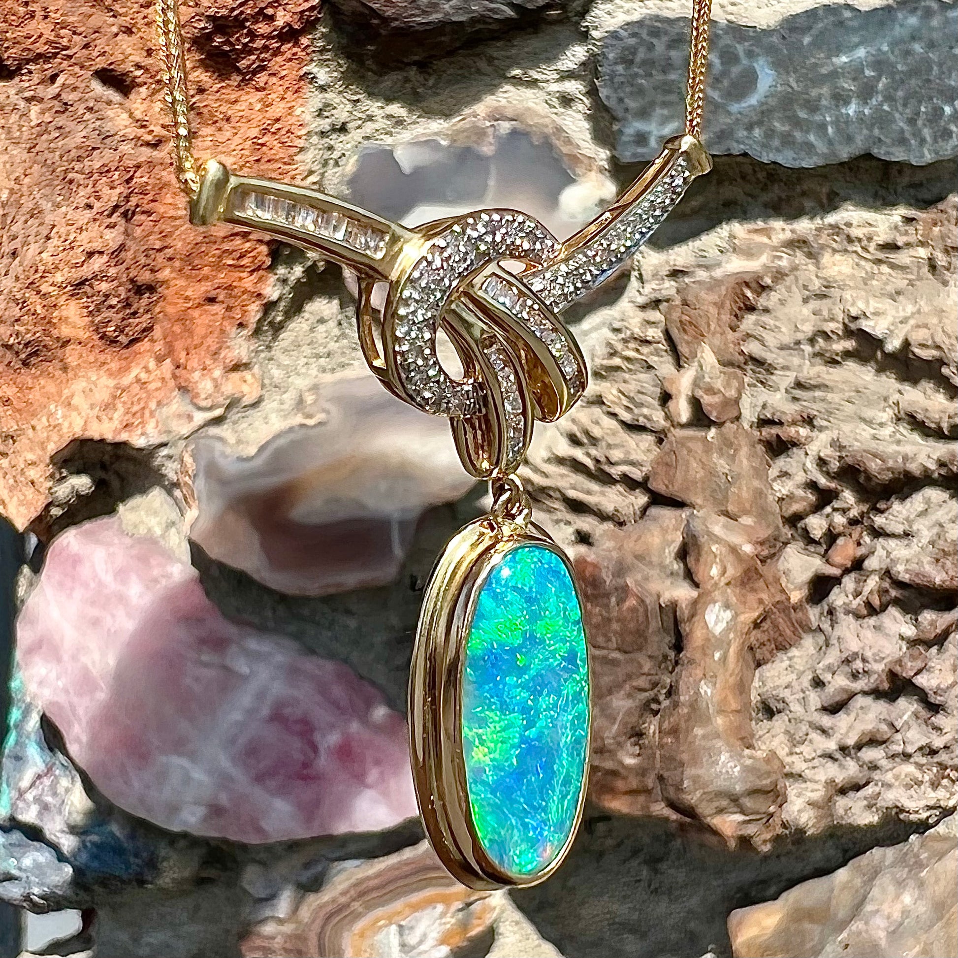 A gold black opal and diamond necklace.  There are round, princess cut, and baguette cut diamonds.