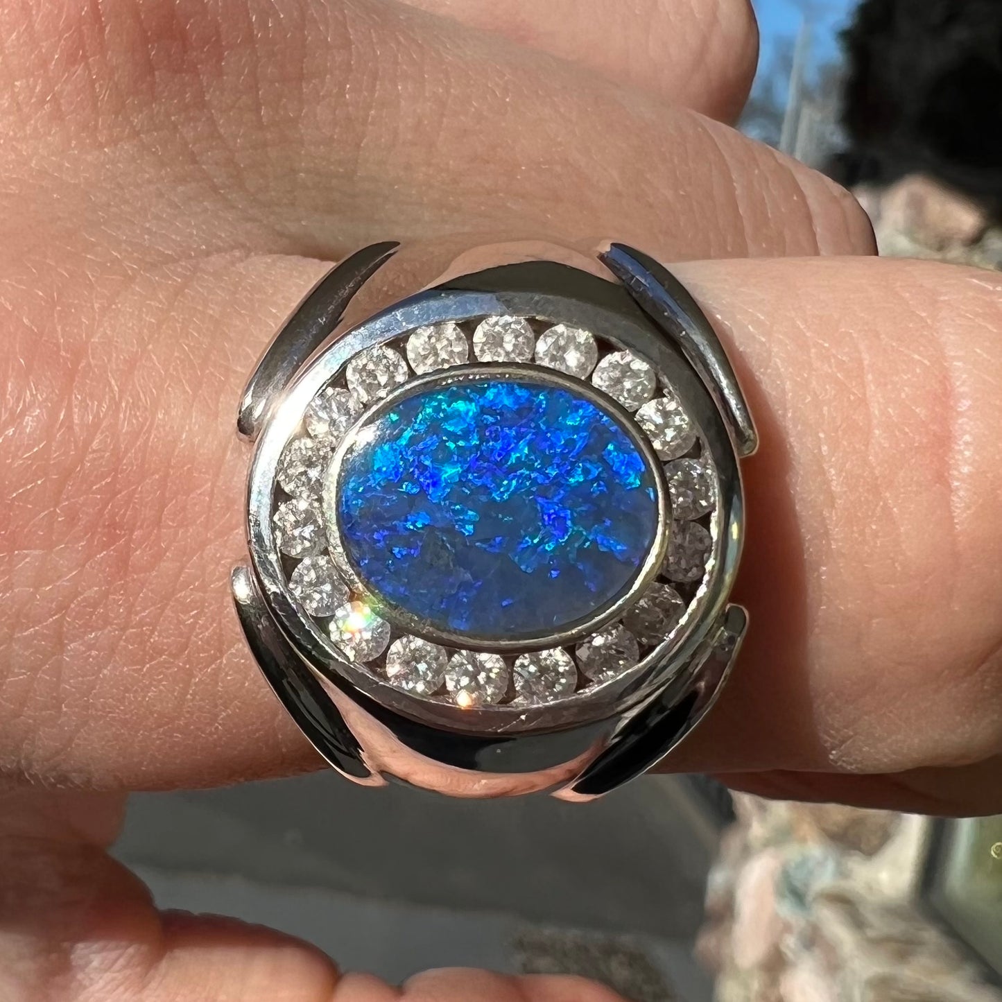 A men's black crystal opal and diamond halo ring in white gold.