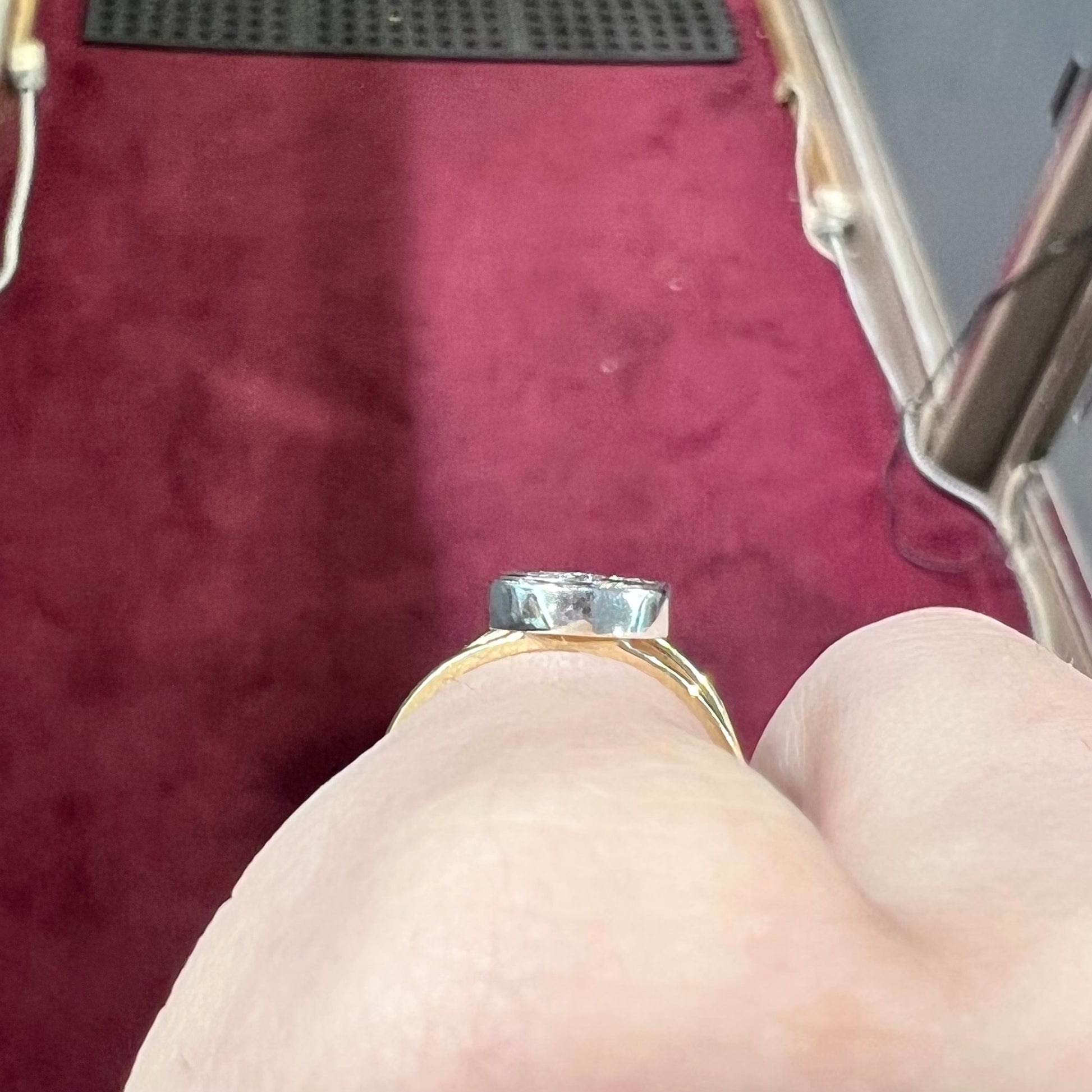 A two tone white and yellow gold initial ring of the letter "S" set with diamonds.