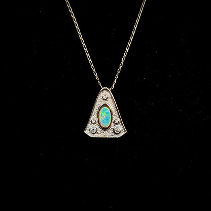 A triangular gold pendant set with five round diamonds and a white crystal opal with green fire.