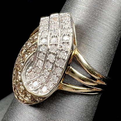 A ladies' 10 karat yellow gold split shank ring pave set with white and champagne colored diamonds.