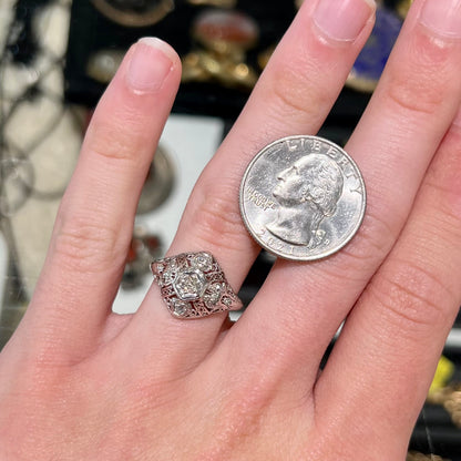 An antique ladies' platinum diamond filigree engagement ring.  The center stone is an old European cut diamond.