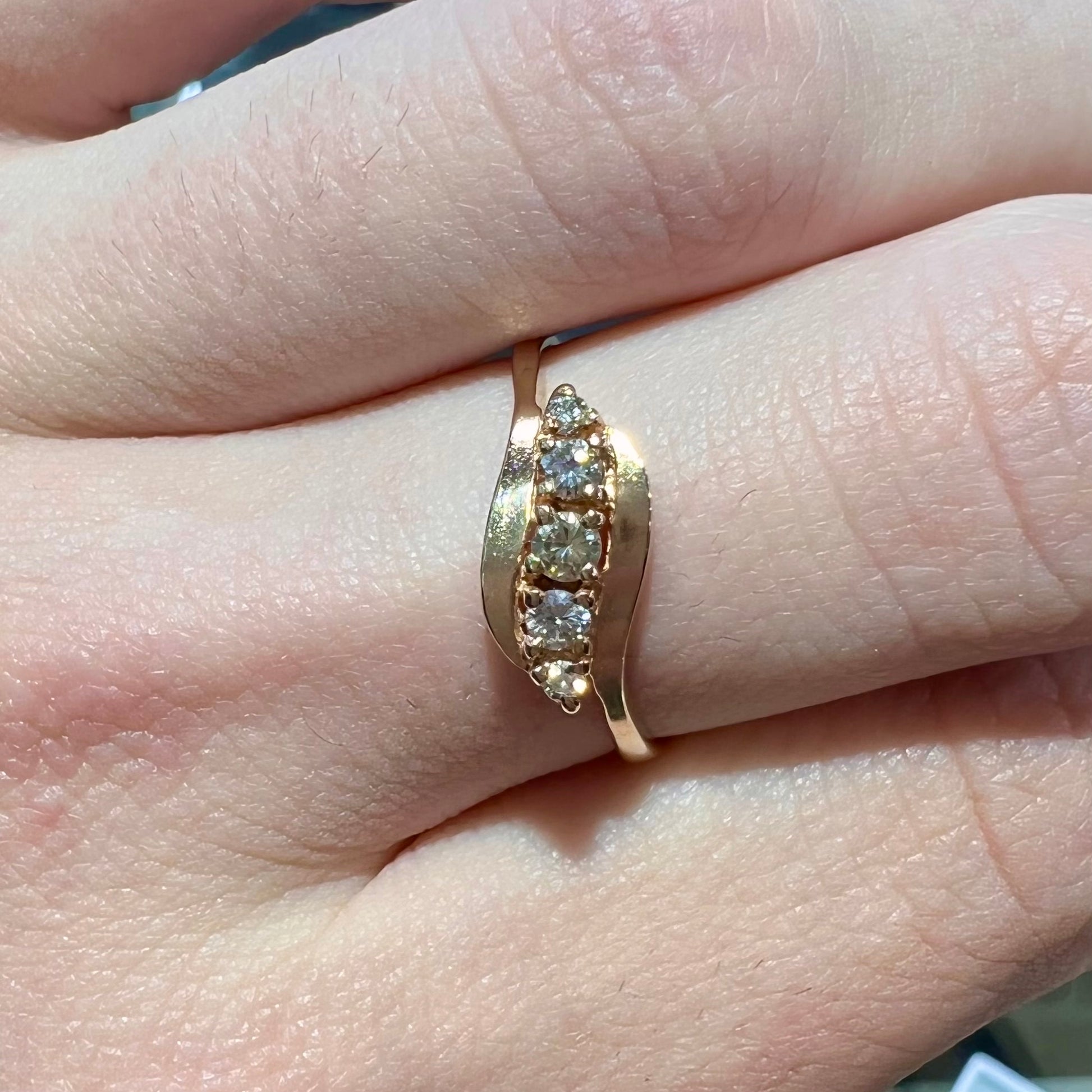 A yellow gold ladies' promise ring set with five Standard Round Brilliant Cut diamonds.