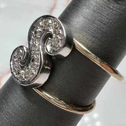 A two tone white and yellow gold initial ring of the letter "S" set with diamonds.