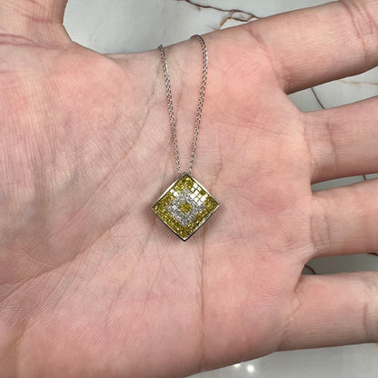 A square shaped necklace set with princess cut yellow and white diamonds in a white gold setting on a white gold chain.