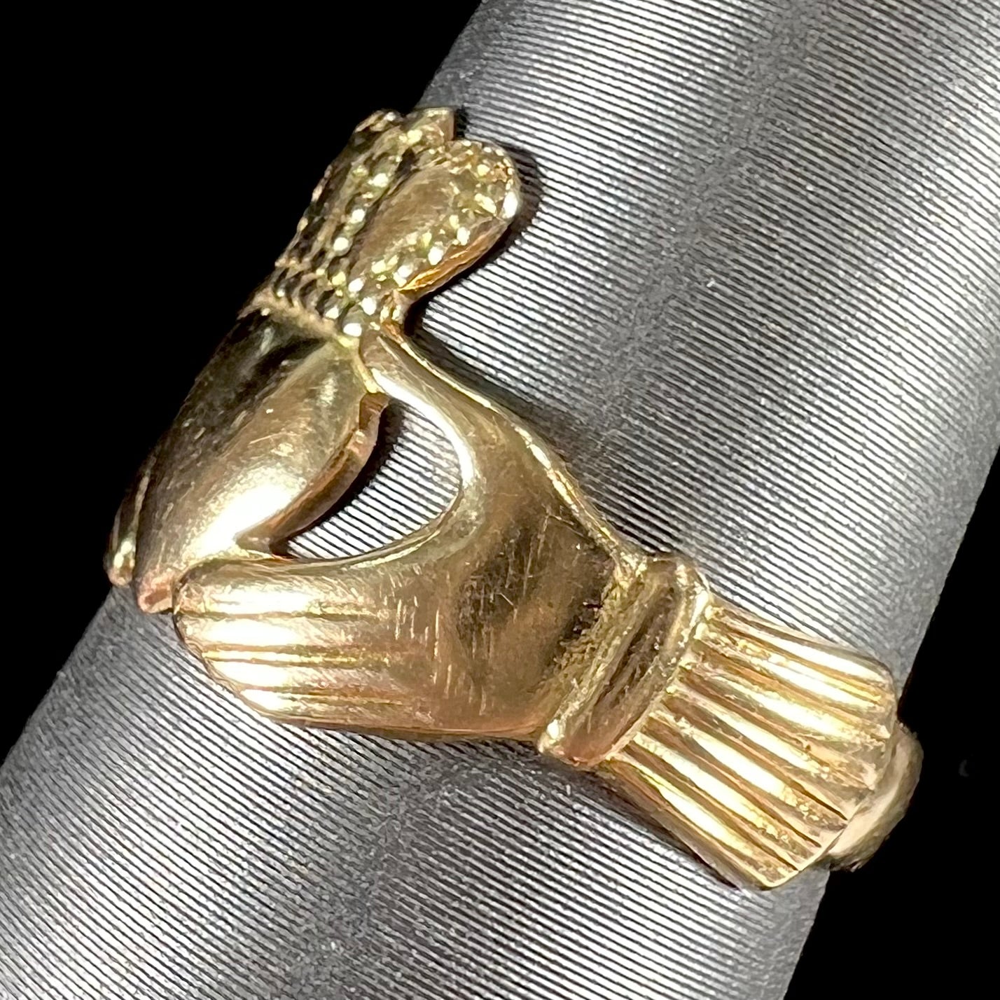 A ladies' 14 karat yellow gold Irish claddagh ring stamped with the maker's hallmarks.