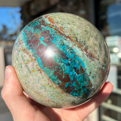 A stone sphere cut from Eilat Stone, mined in Israel.  Material contains turquoise, chrysocolla, azurite, malachite, and cuprite.