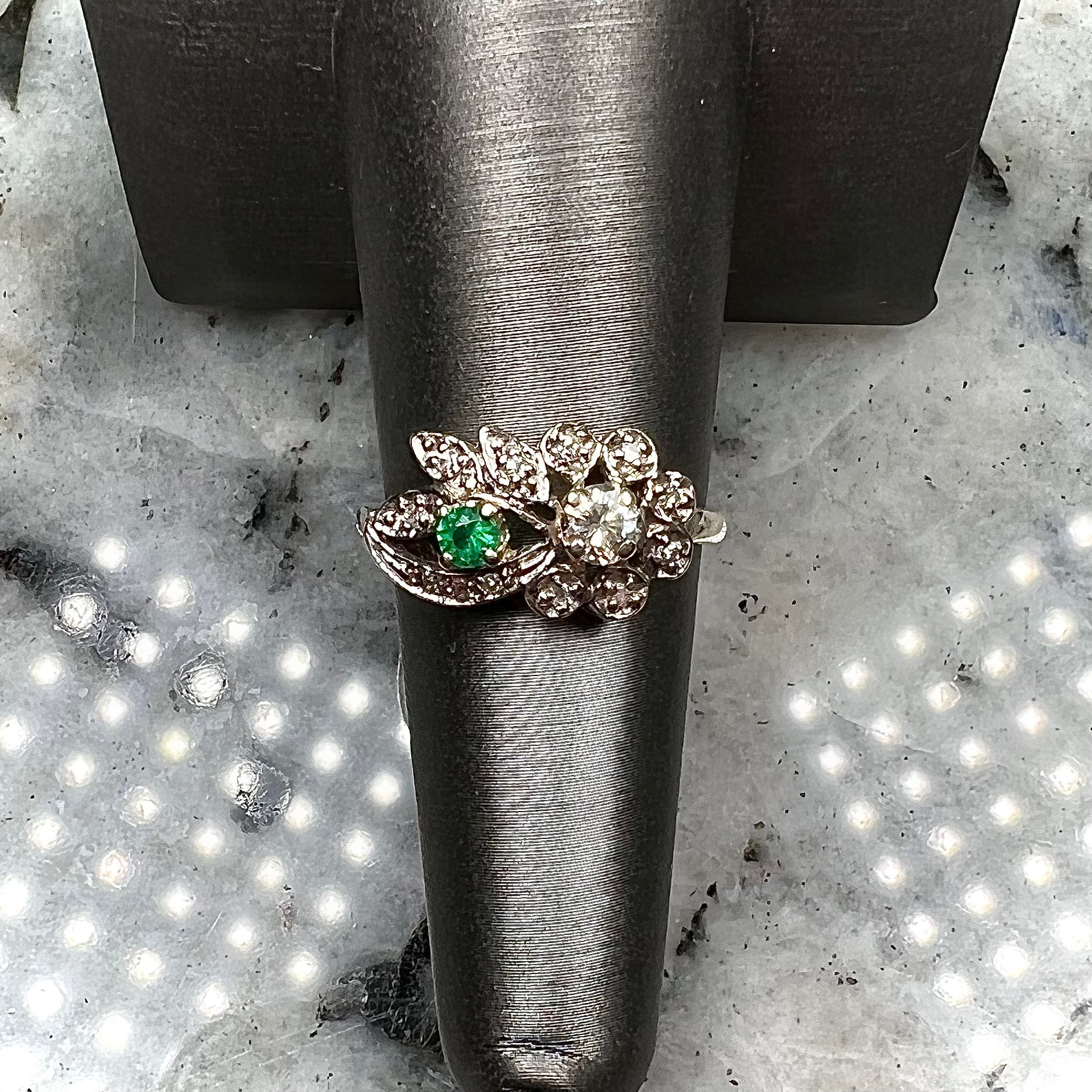 Vintage gold round cut emerald and diamond ring.