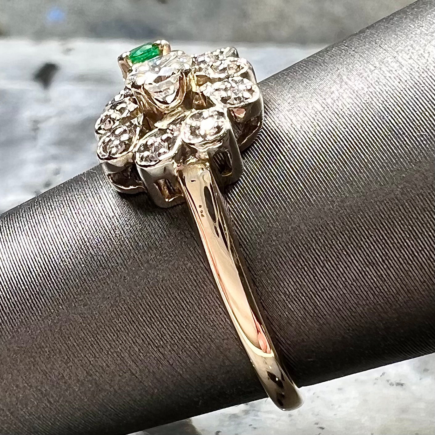 Vintage gold round cut emerald and diamond ring.