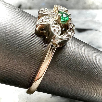Vintage gold round cut emerald and diamond ring.