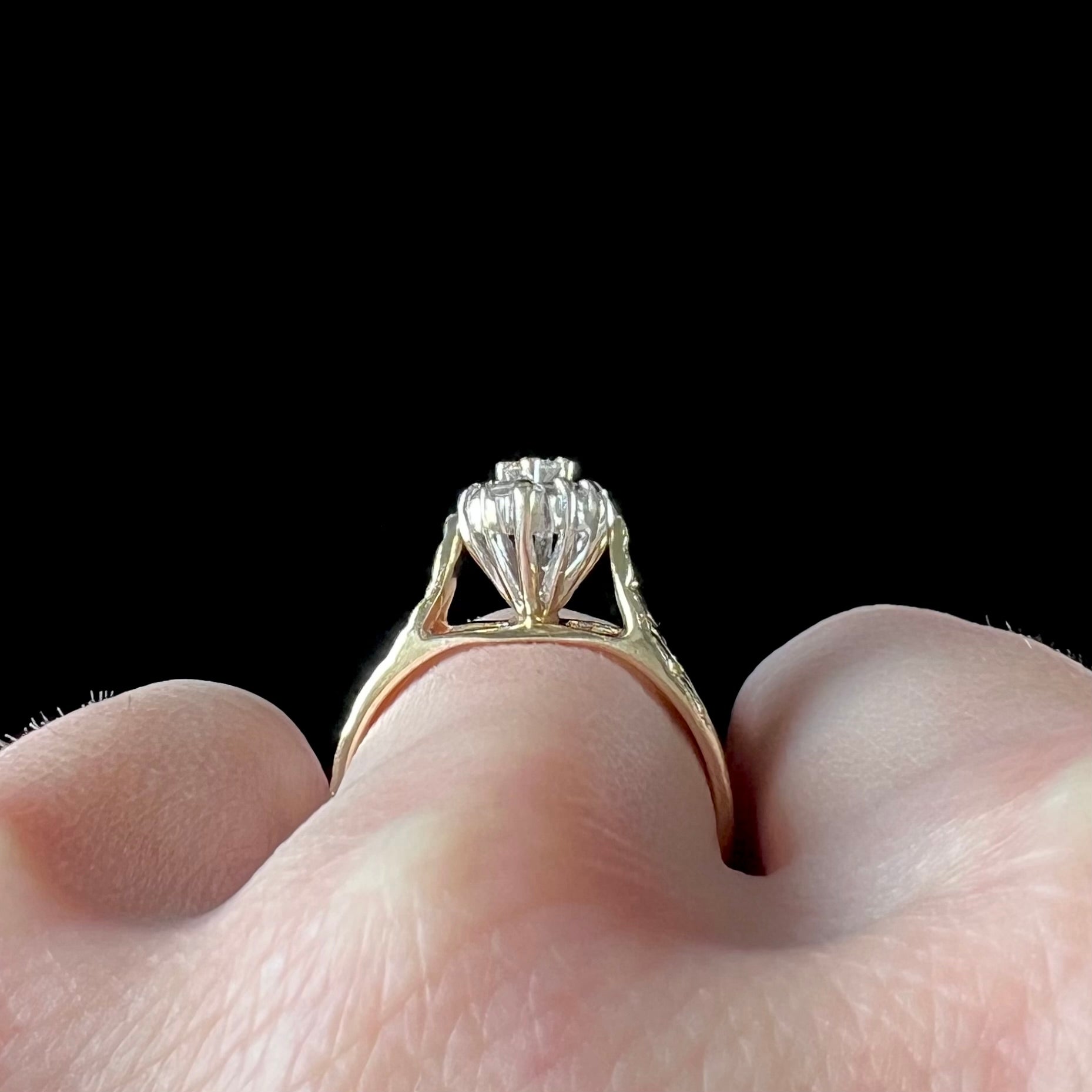 A ladies' estate diamond cluster ring cast in yellow gold.  The shank has a nugget design.