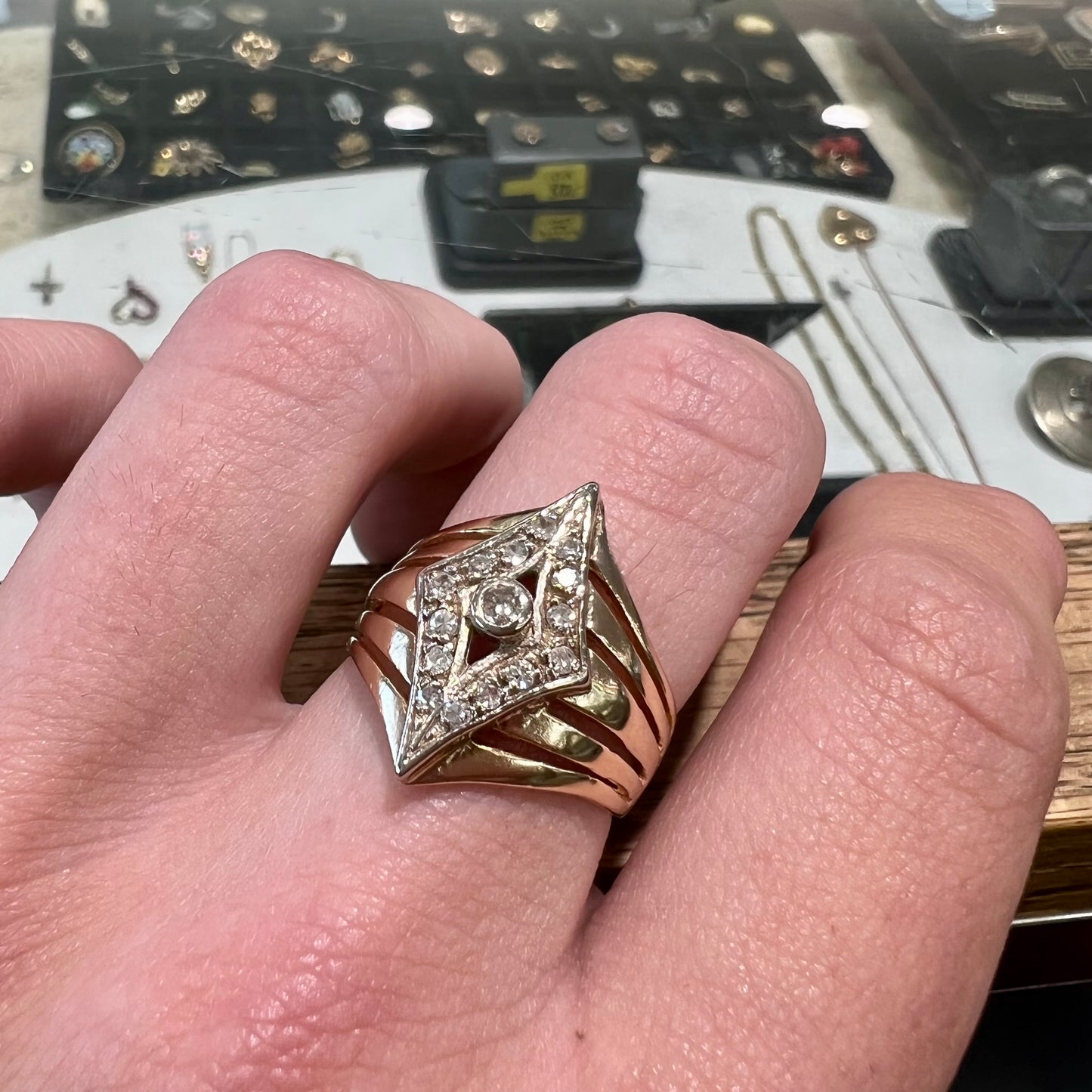 An estate ladies' gold diamond ring.  The shape of the ring resembles an art deco style diamond.