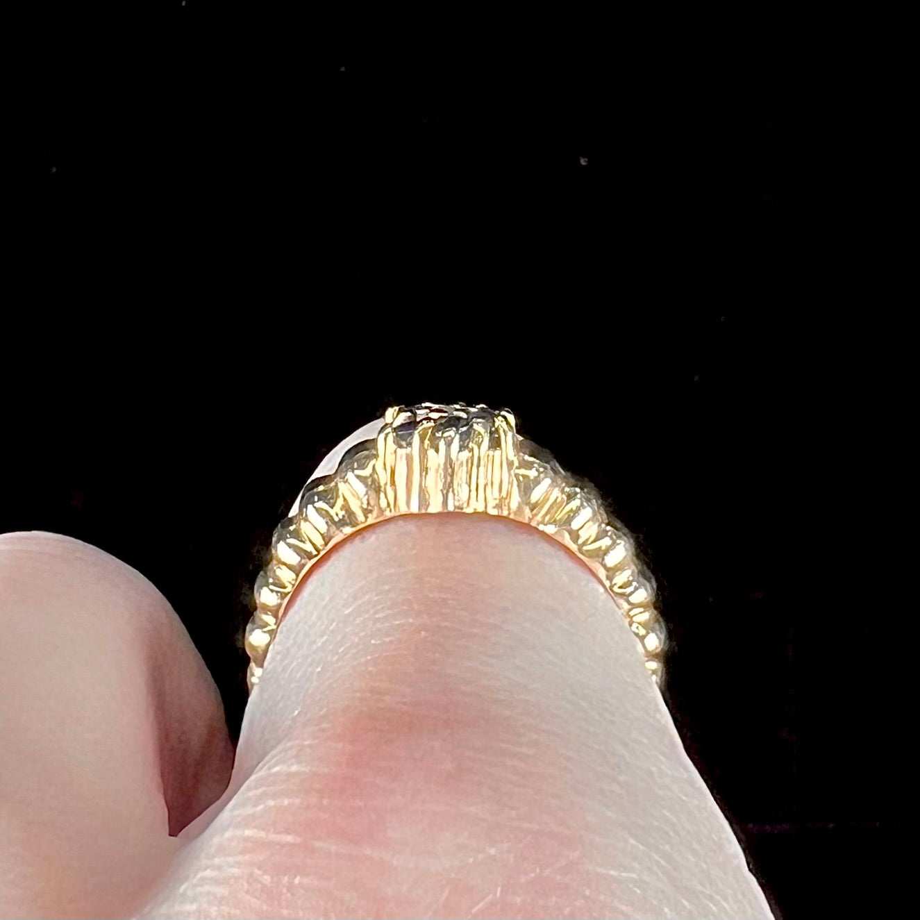 A ladies' yellow gold cluster ring set with round blue sapphires and a round diamond.