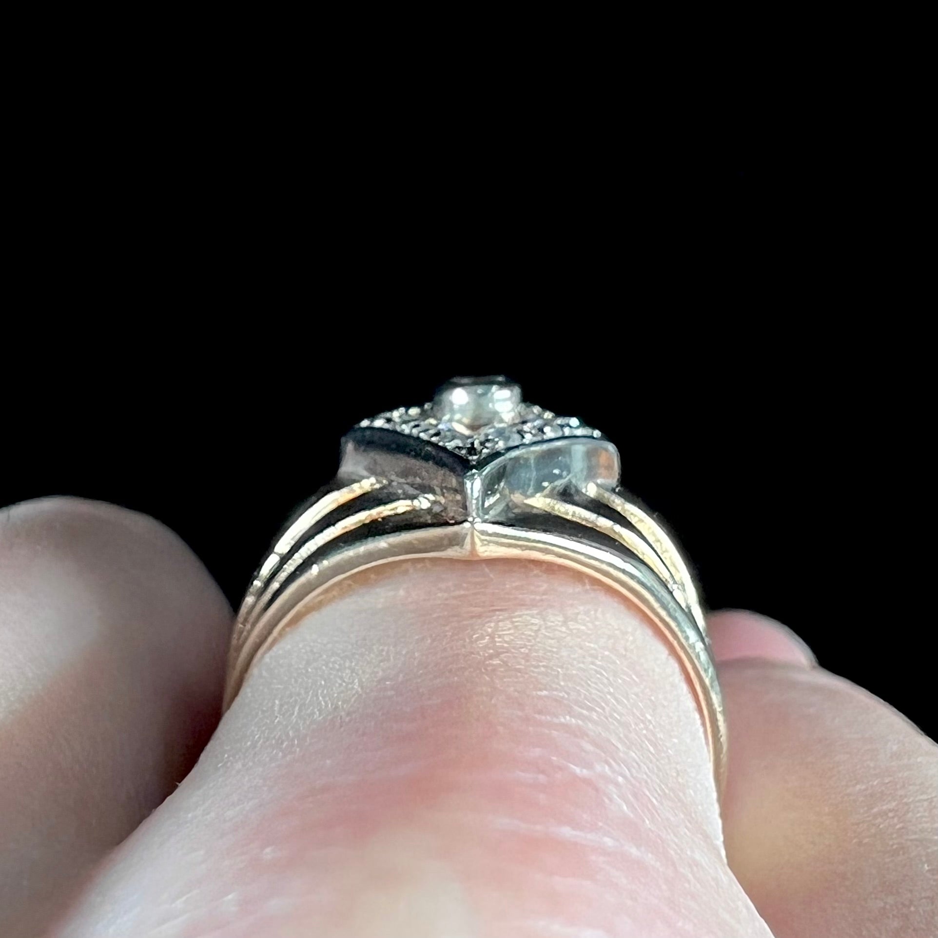 An estate ladies' gold diamond ring.  The shape of the ring resembles an art deco style diamond.