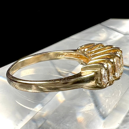 An estate yellow gold ring prong set with seven marquise cut diamonds.