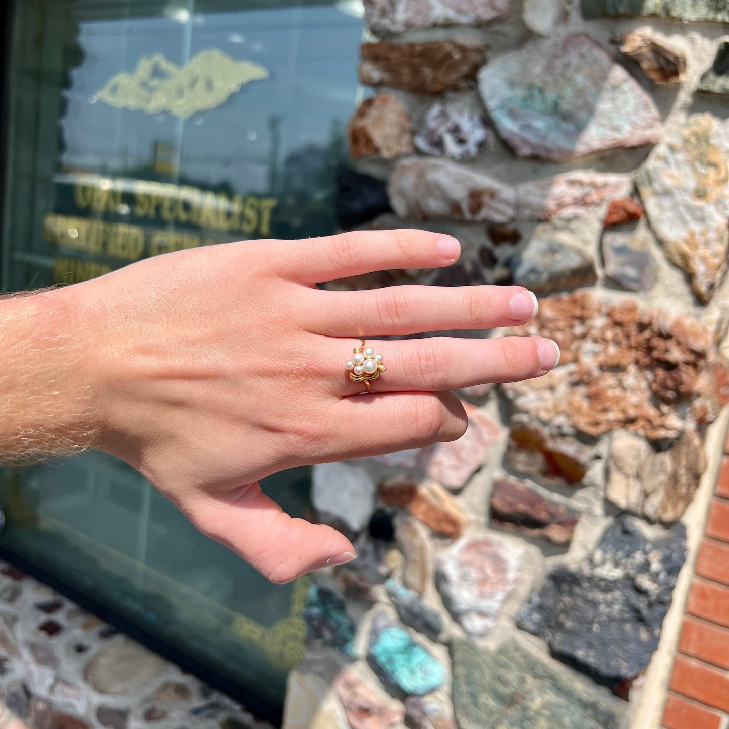 A yellow gold Akoya pearl cluster ring.  The pearls are round with pink overtones and resemble bubbles.