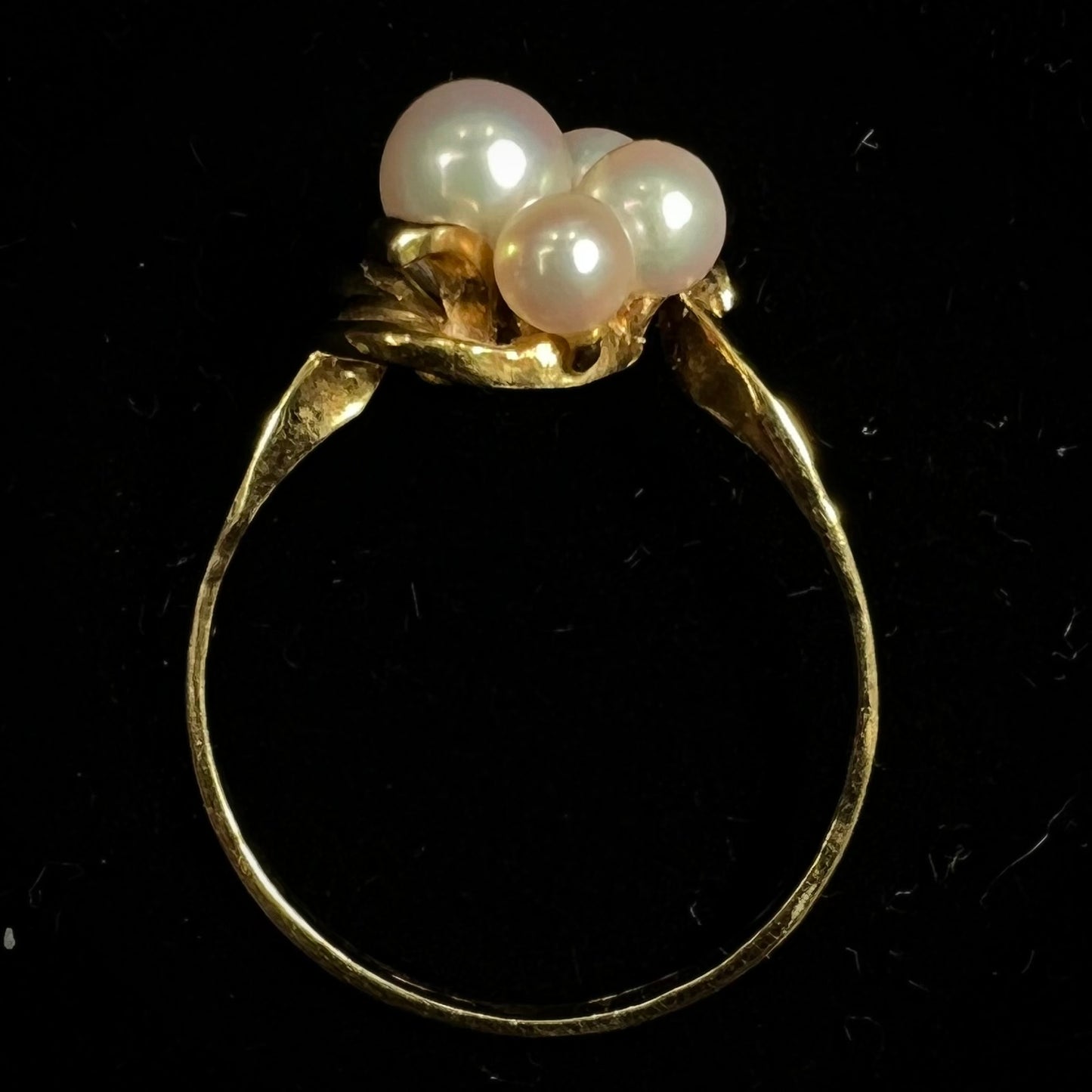 A yellow gold Akoya pearl cluster ring.  The pearls are round with pink overtones and resemble bubbles.