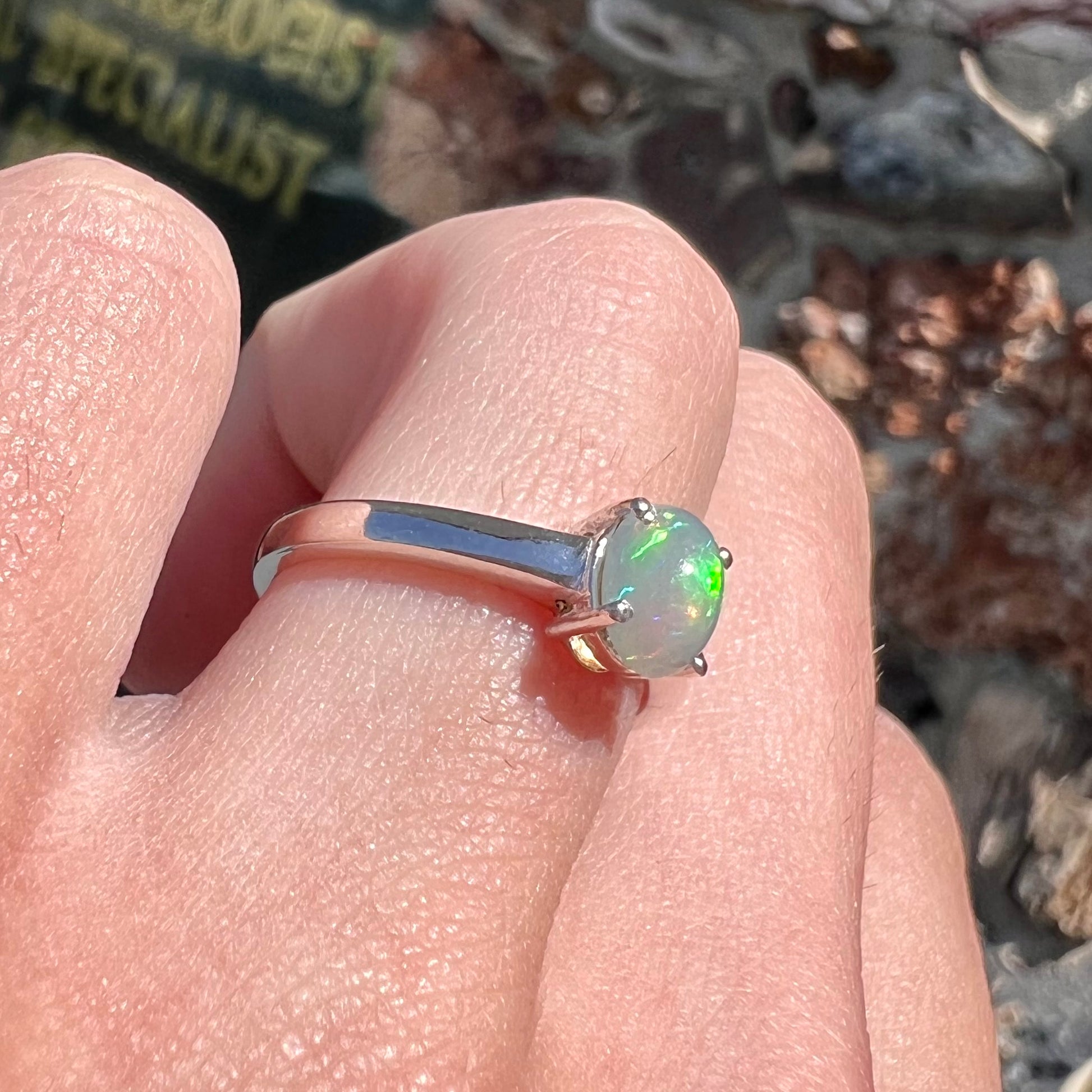 A silver, prong set, oval cabochon cut Ethiopian opal solitaire ring.