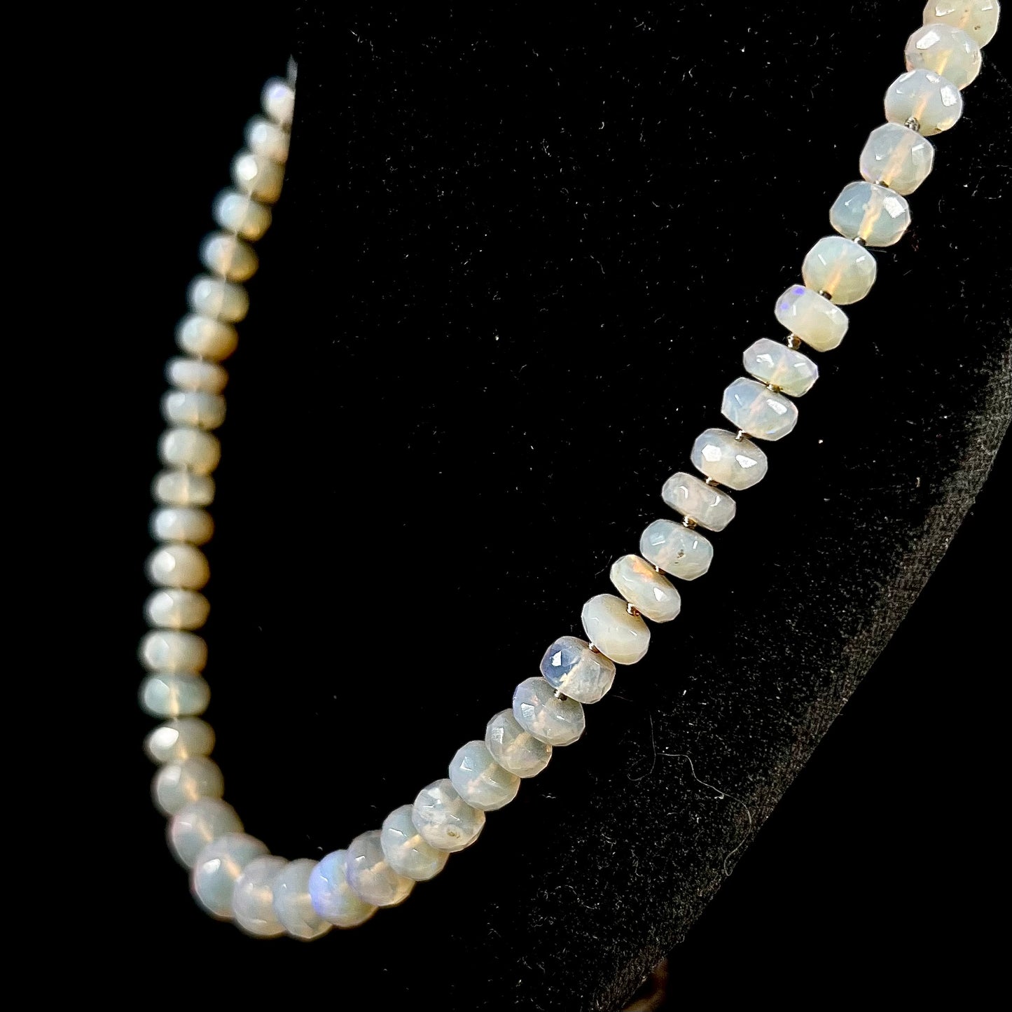 A necklace strand of faceted white crystal opal beads with a white gold clasp.