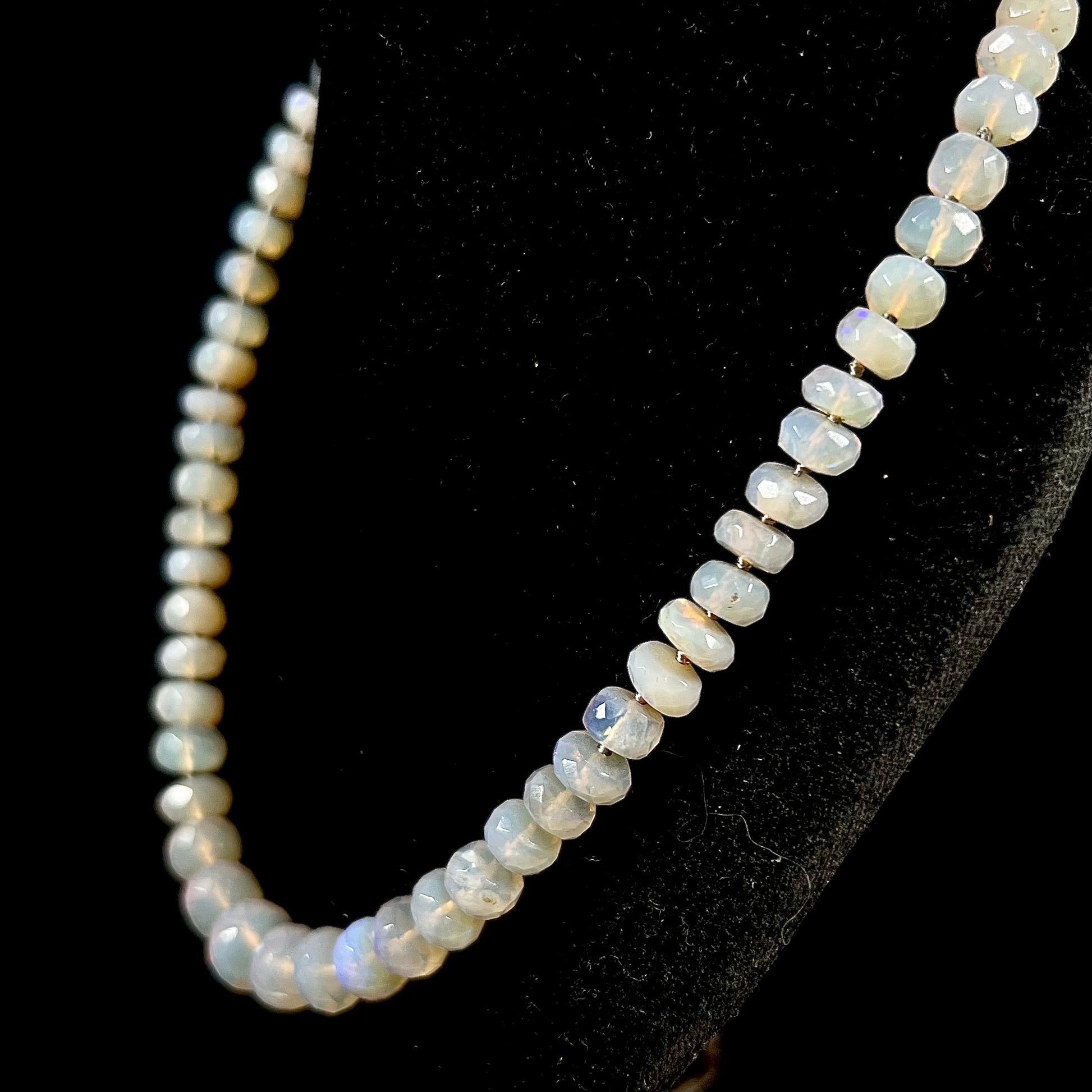 A necklace strand of faceted white crystal opal beads with a white gold clasp.