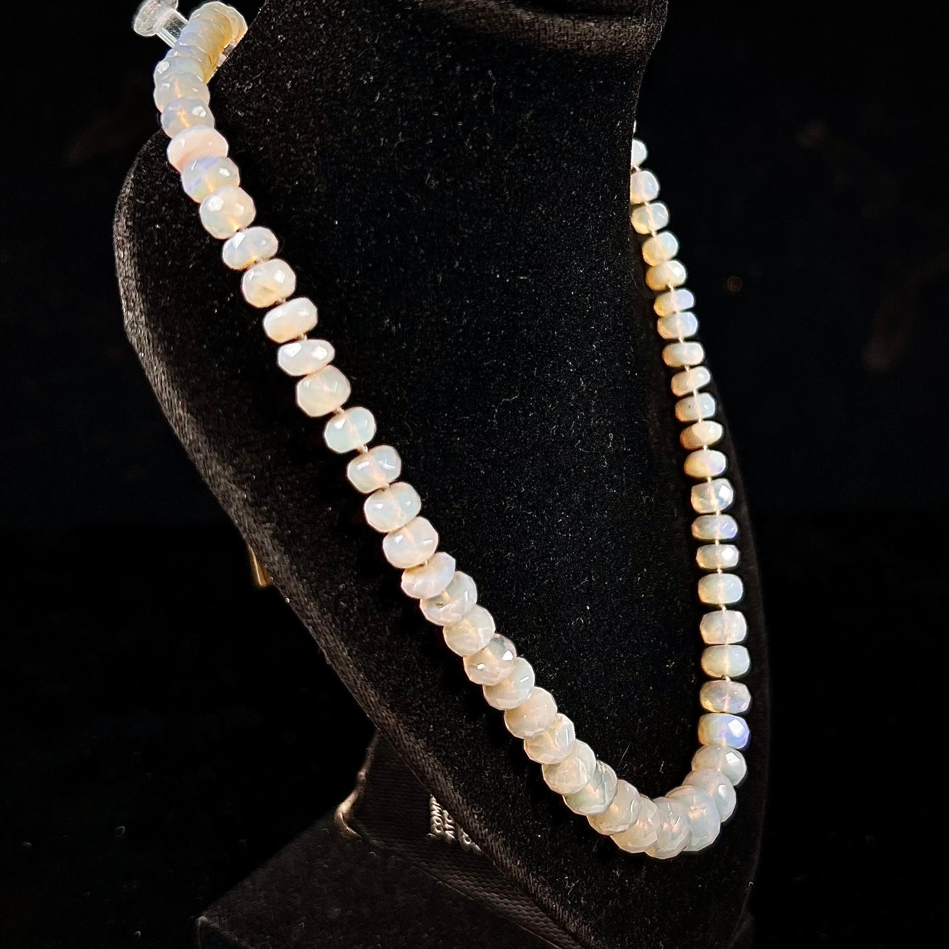 A necklace strand of faceted white crystal opal beads with a white gold clasp.