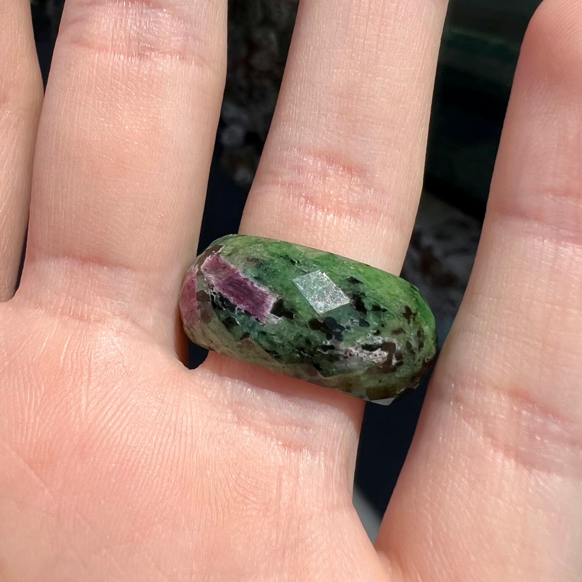 A faceted, carved stone ring made form ruby in zoisite.