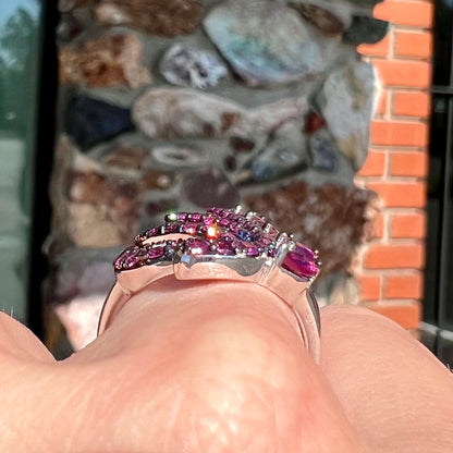 A sterling silver, feather shaped ring set with round and marquise cut rhodolite garnet stones.