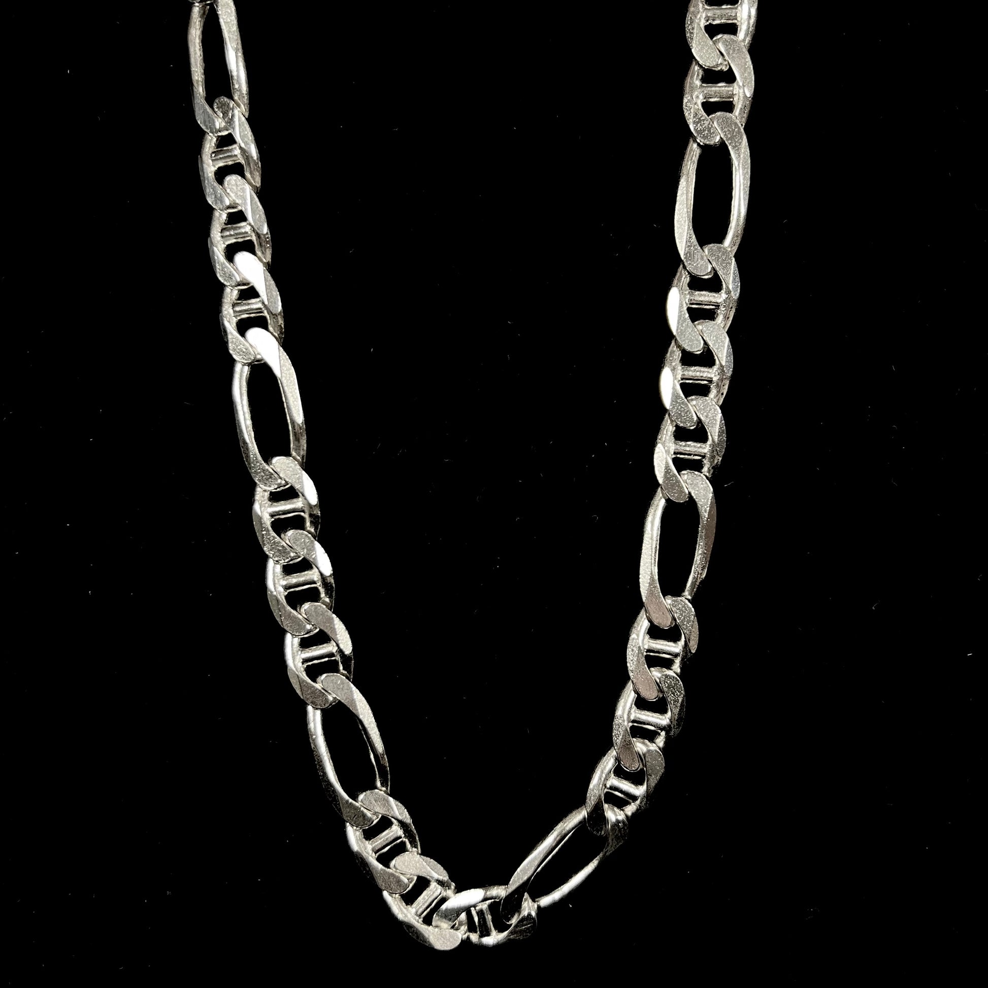 A men's sterling silver figaro anchor chain.  The chain measures 22 inches in length and the links are 11mm wide.