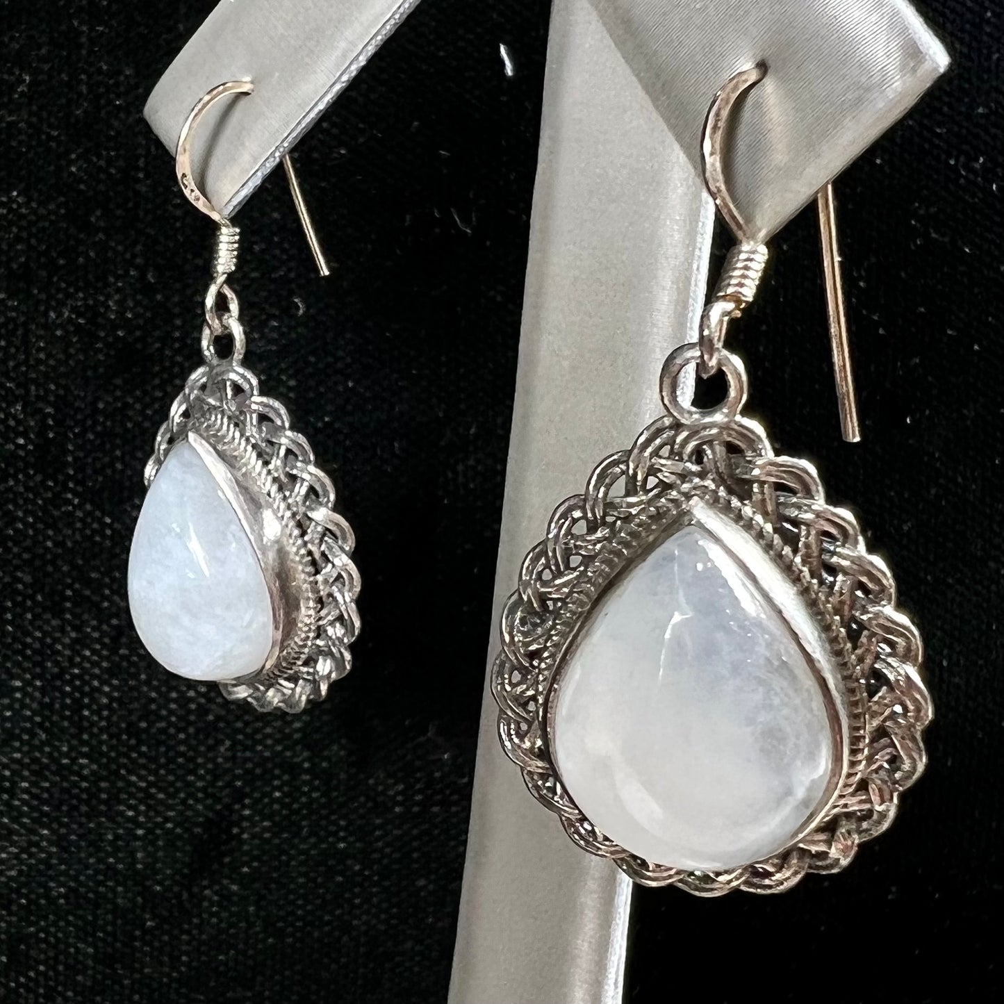 Silver filigree dangle wire earrings set with pear shape moonstones.