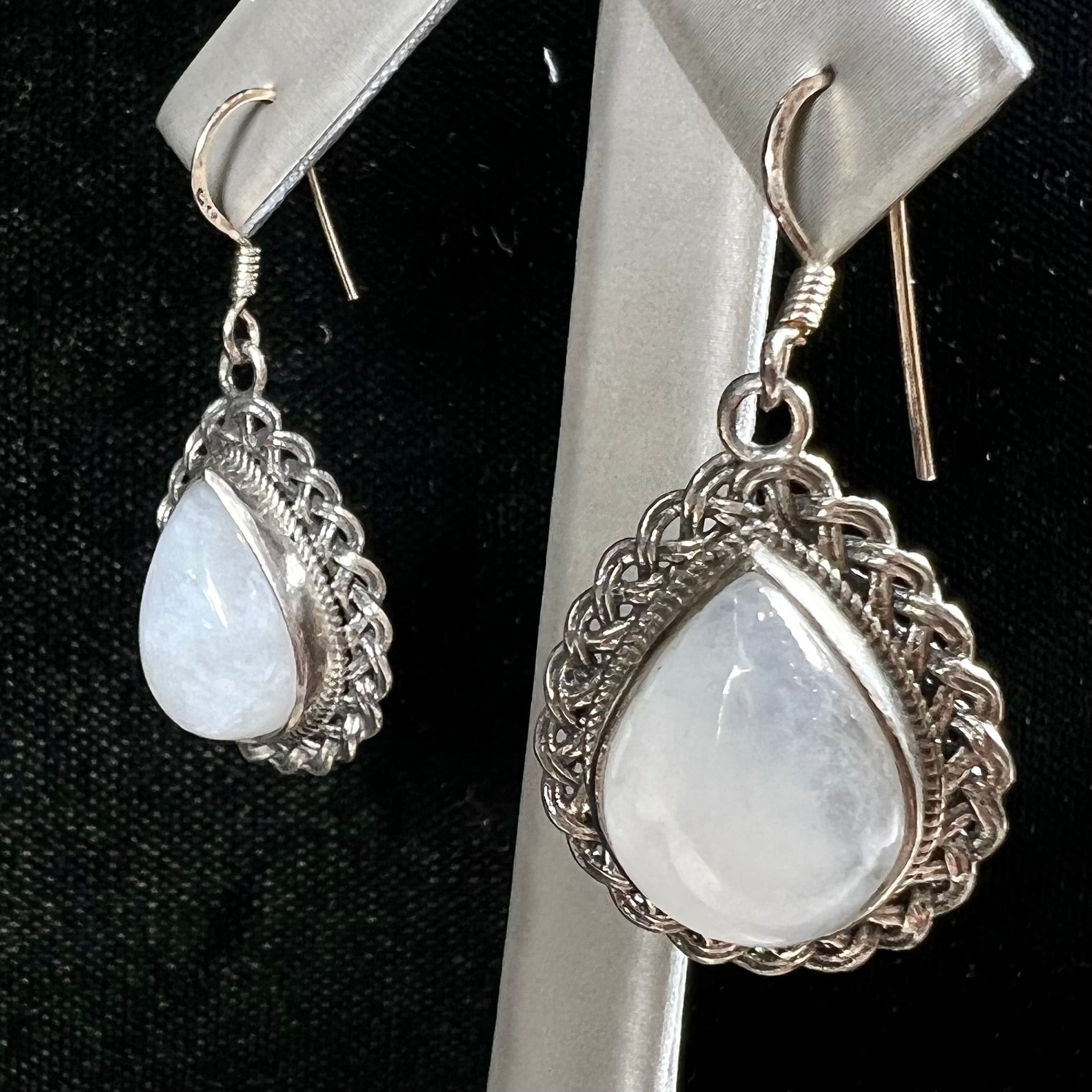 Silver filigree dangle wire earrings set with pear shape moonstones.