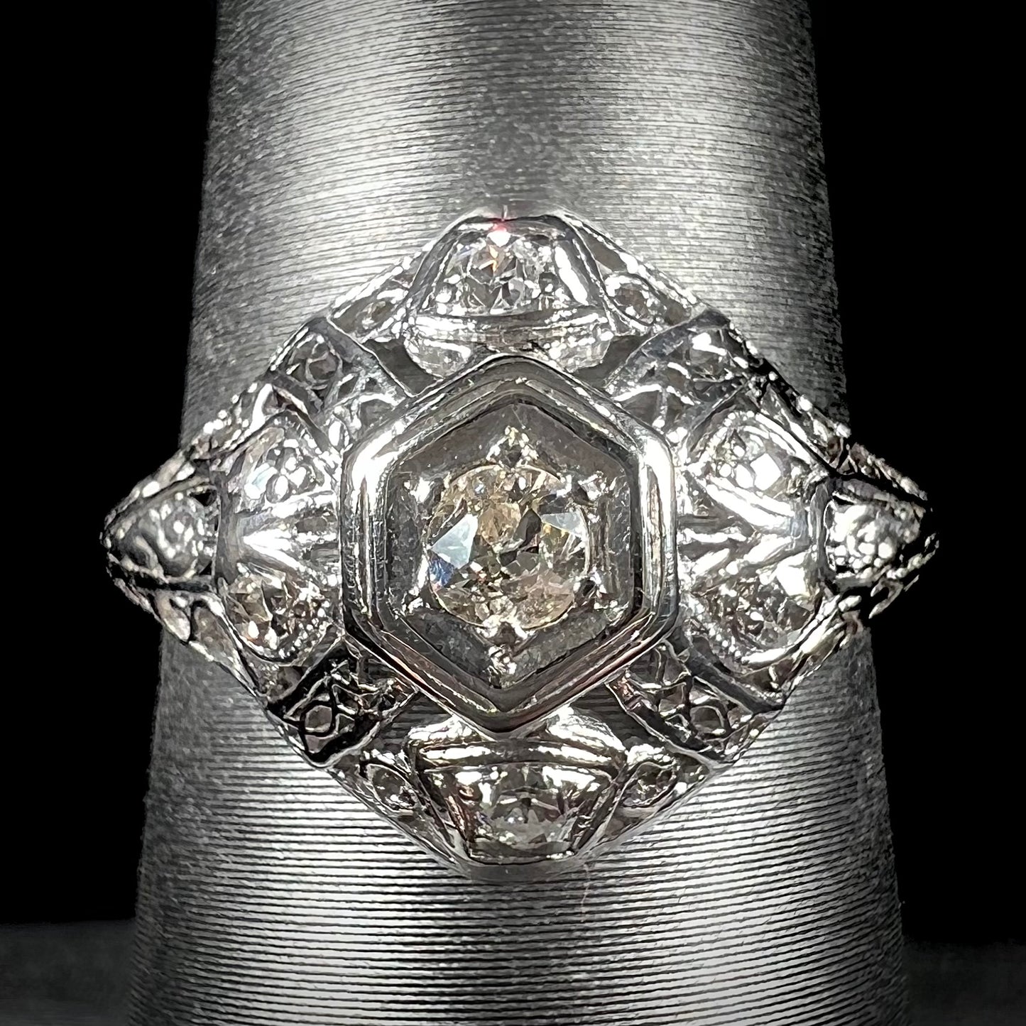 An antique ladies' platinum diamond filigree engagement ring.  The center stone is an old European cut diamond.