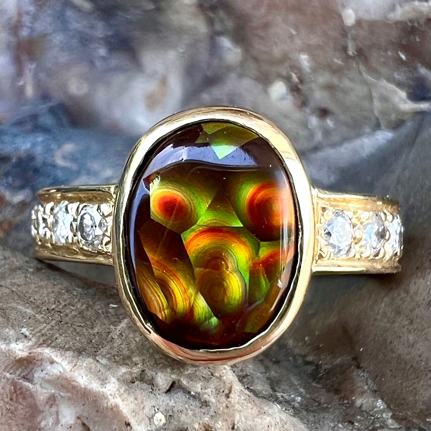 A ladies' gold fire agate and diamond engagement ring.