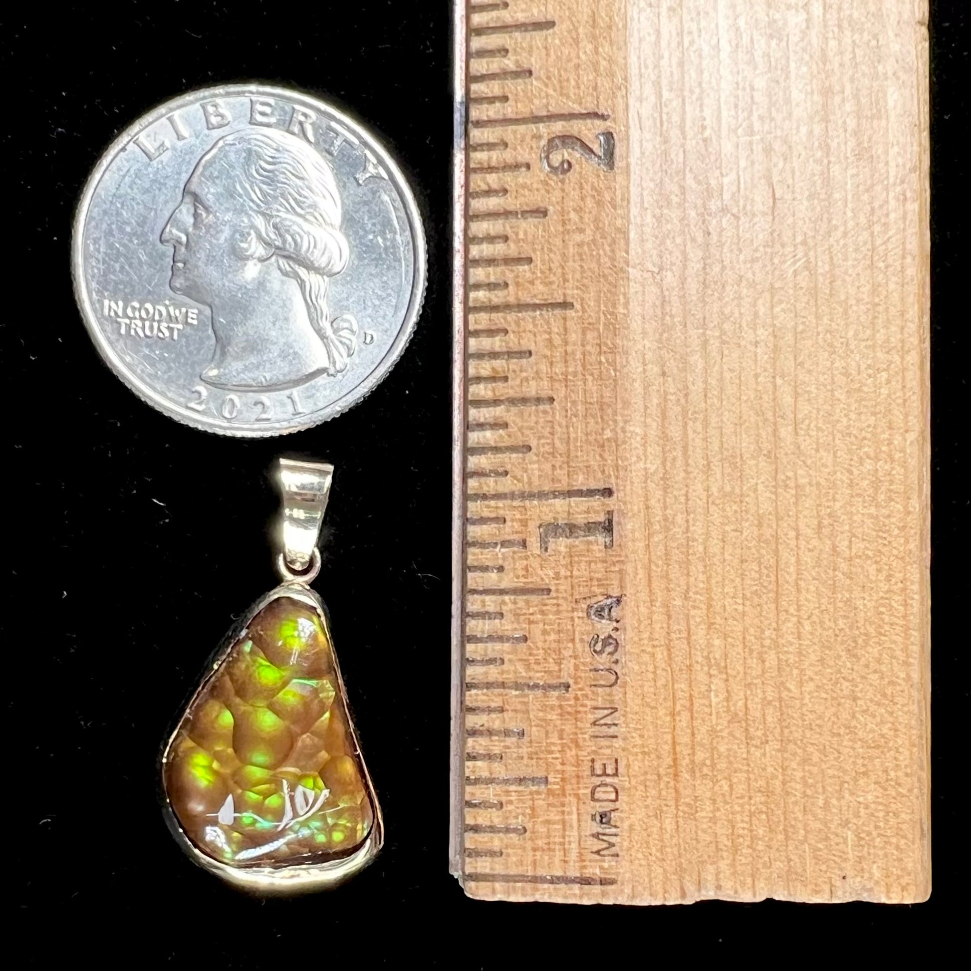 A handmade yellow gold solitaire pendant set with a green fire agate stone from Mexico.