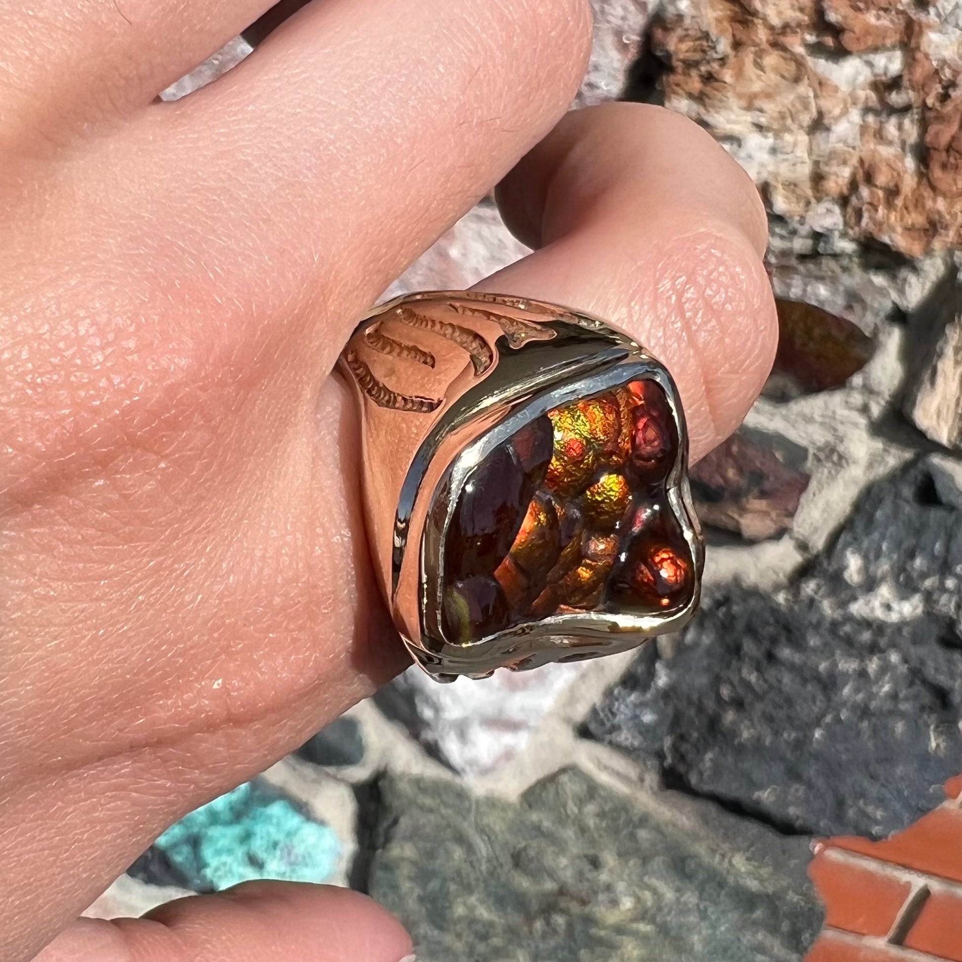 A men's custom fire agate solitaire ring cast in yellow gold.