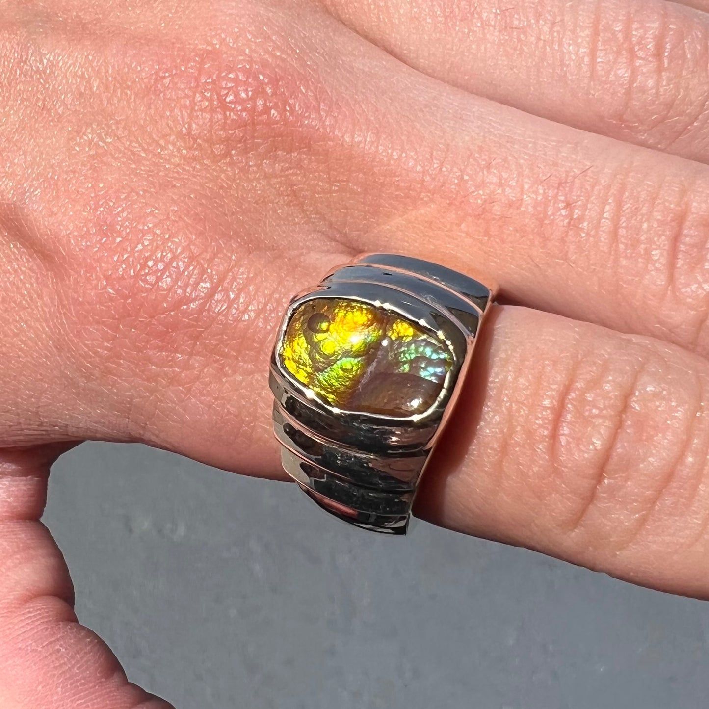 Men's fire agate solitaire ring cast in yellow gold.  The ring is a step design.