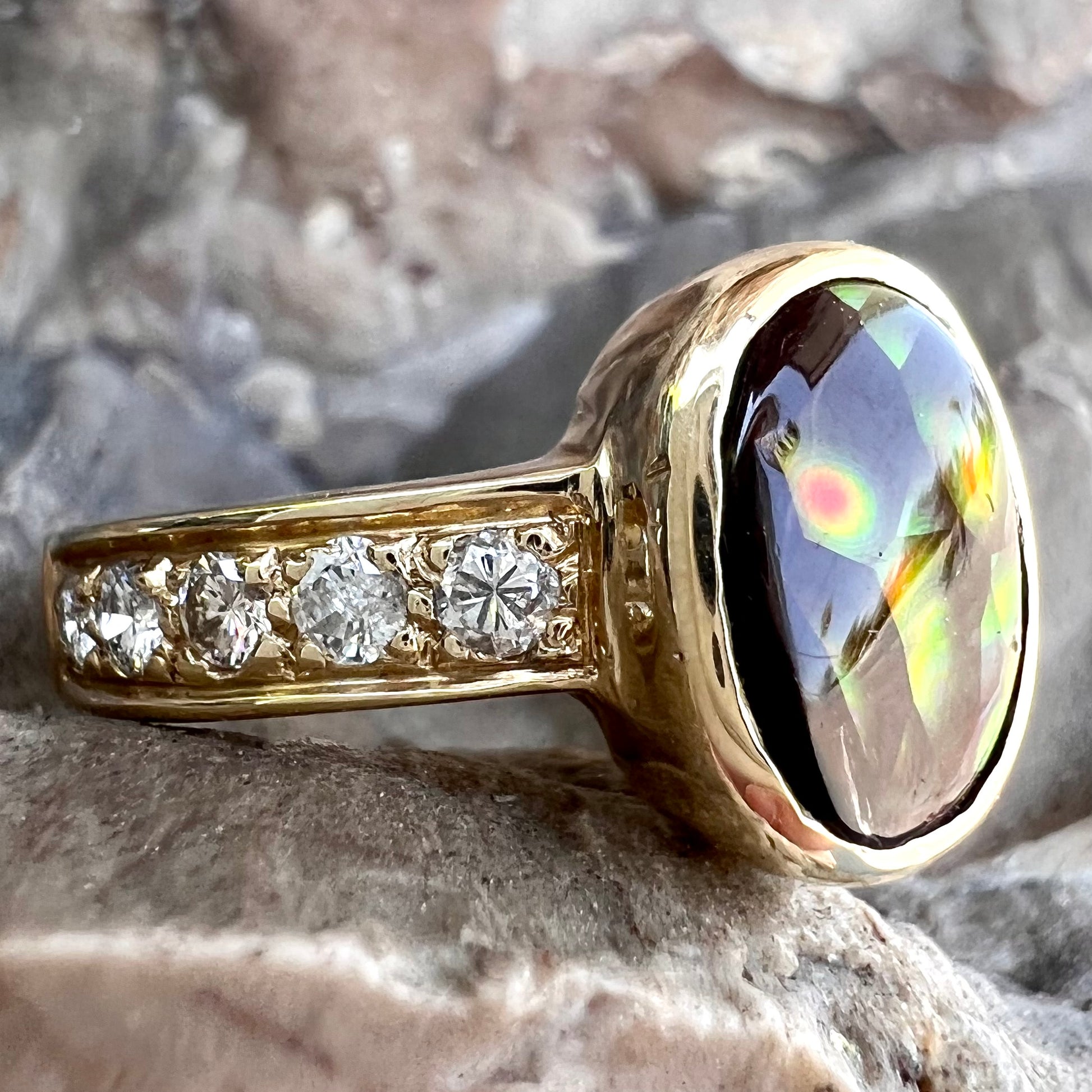 A ladies' gold fire agate and diamond engagement ring.