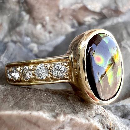 A ladies' gold fire agate and diamond engagement ring.