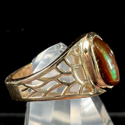 A ladies' yellow gold ring set with two fire agate stones: one green, and one red.
