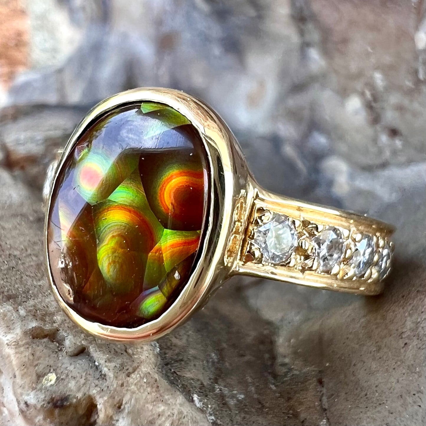 A ladies' gold fire agate and diamond engagement ring.