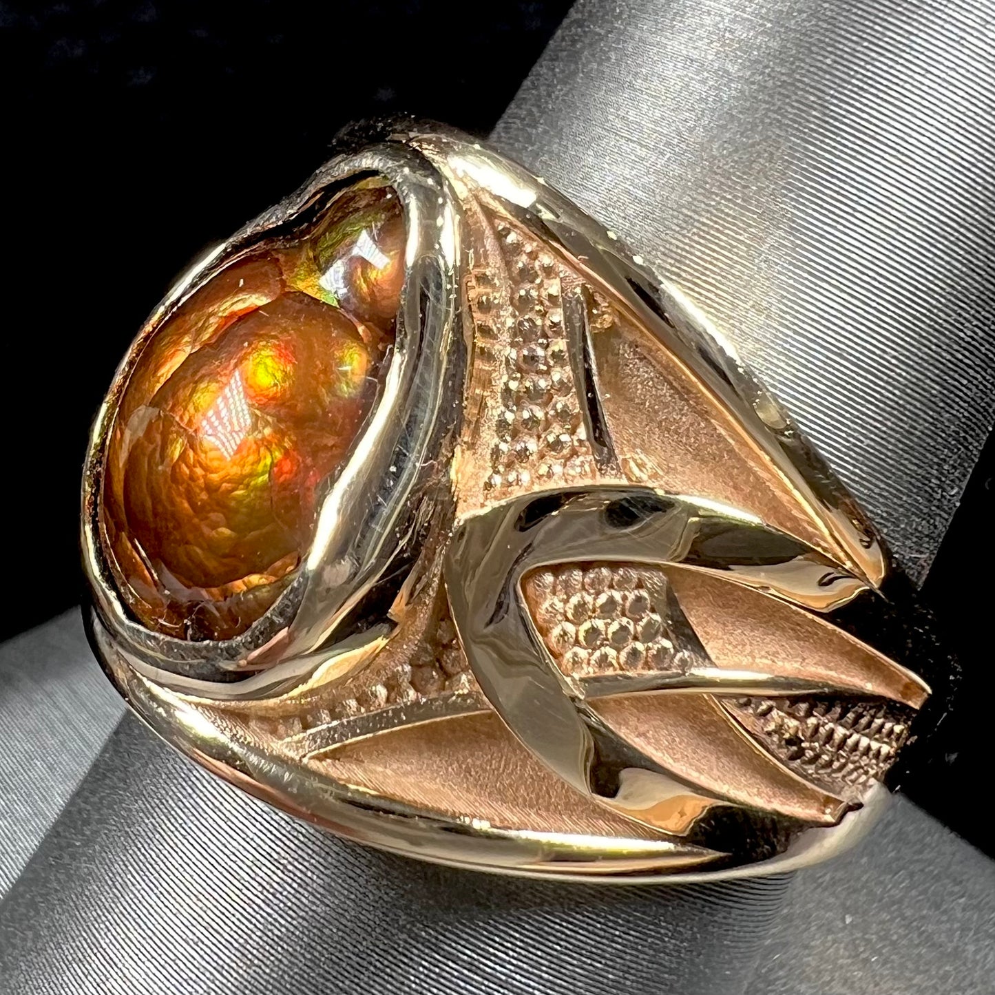 A men's 14kt yellow gold Mexican fire agate ring.