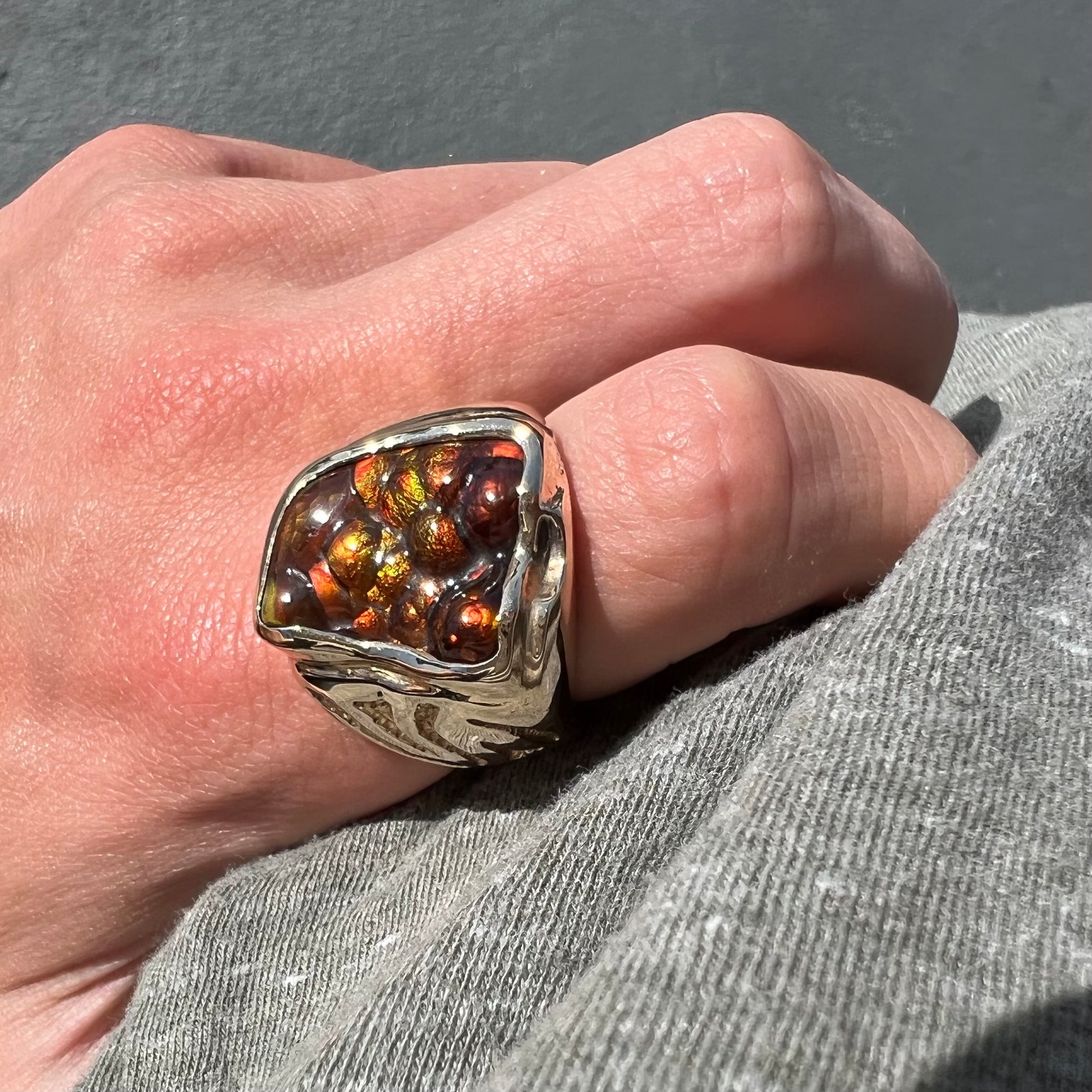 A men's custom fire agate solitaire ring cast in yellow gold.