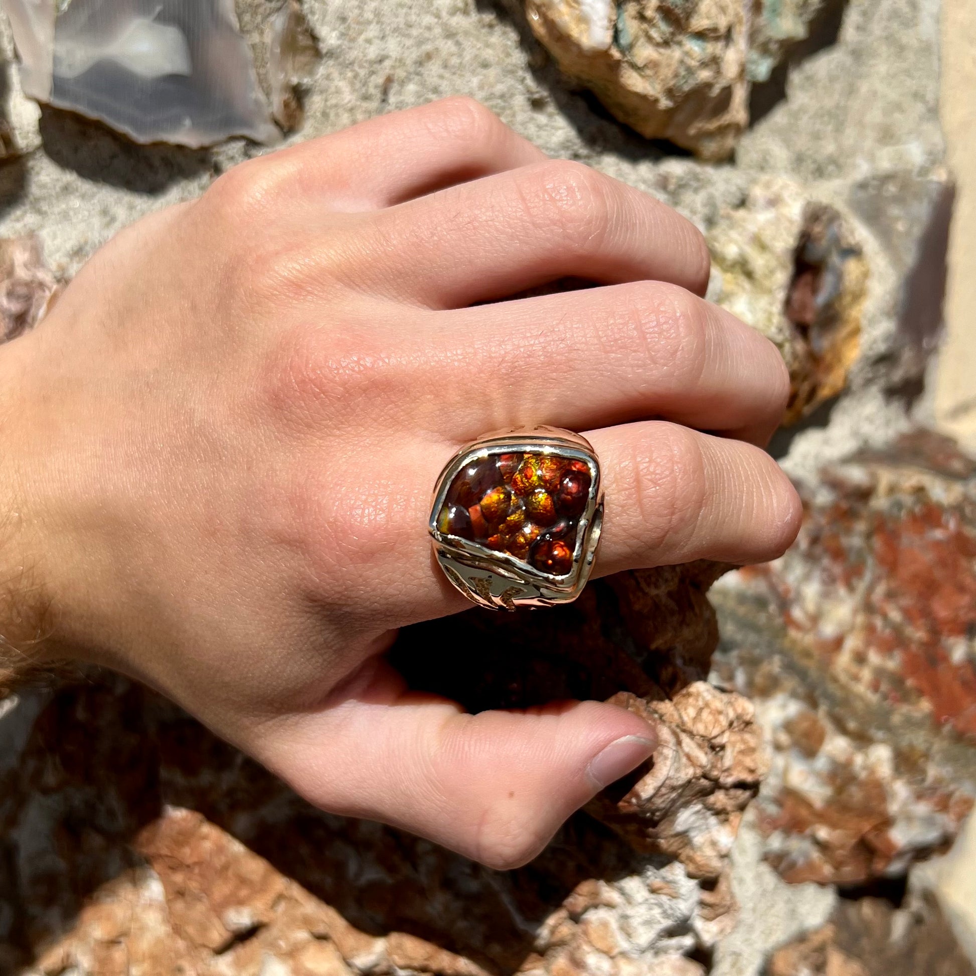 A men's custom fire agate solitaire ring cast in yellow gold.