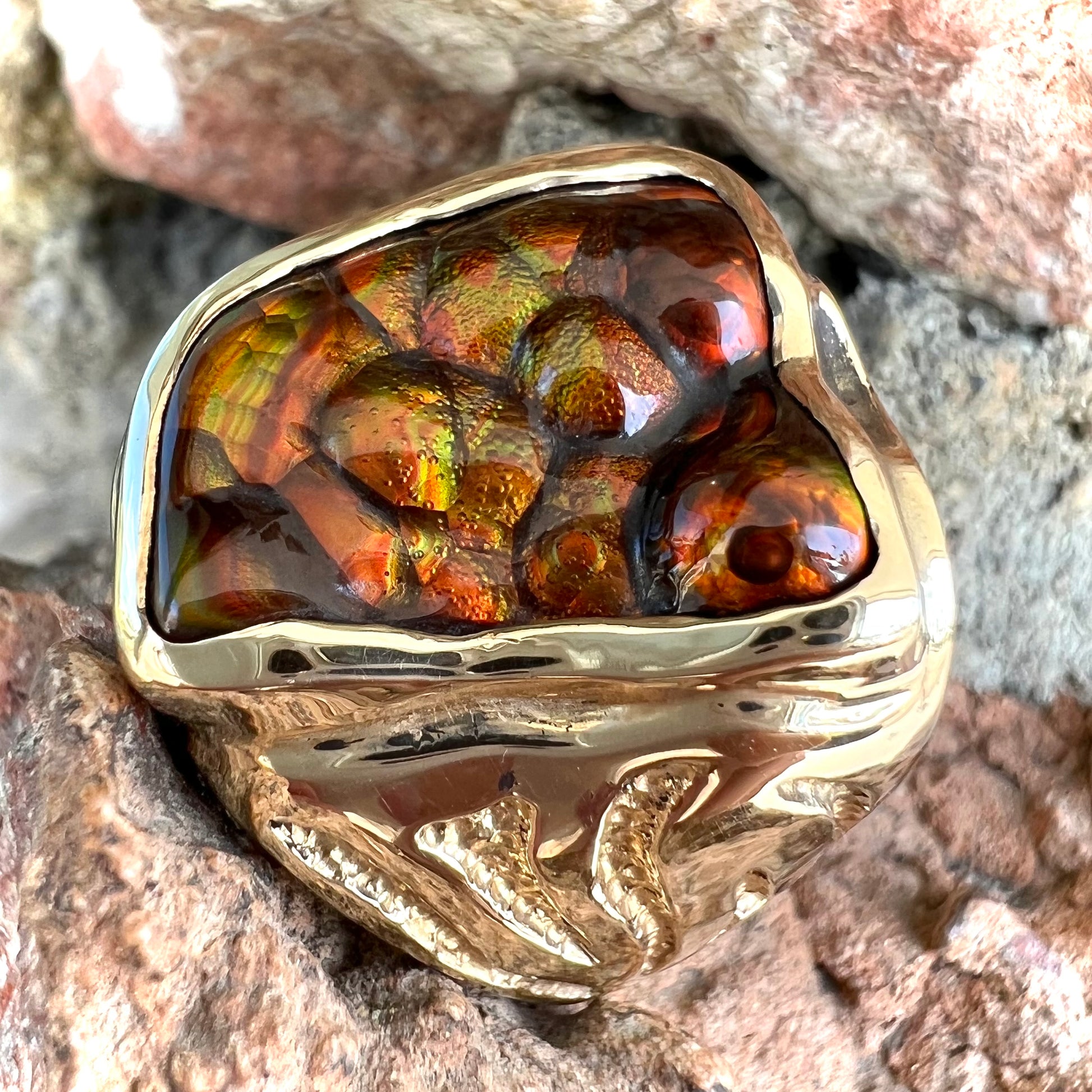 A men's custom fire agate solitaire ring cast in yellow gold.