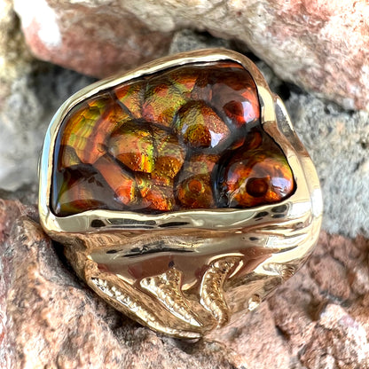 A men's custom fire agate solitaire ring cast in yellow gold.