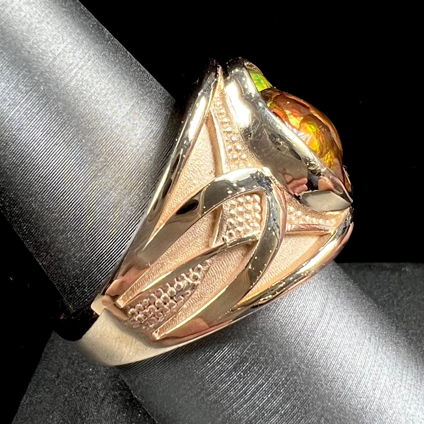 A men's 14kt yellow gold Mexican fire agate ring.