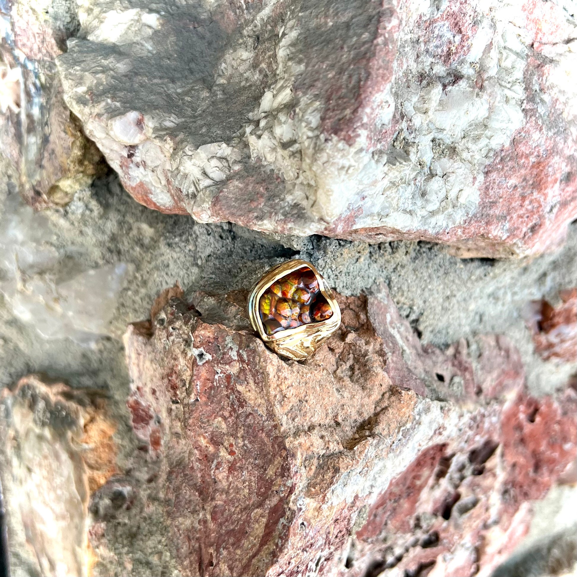 A men's custom fire agate solitaire ring cast in yellow gold.
