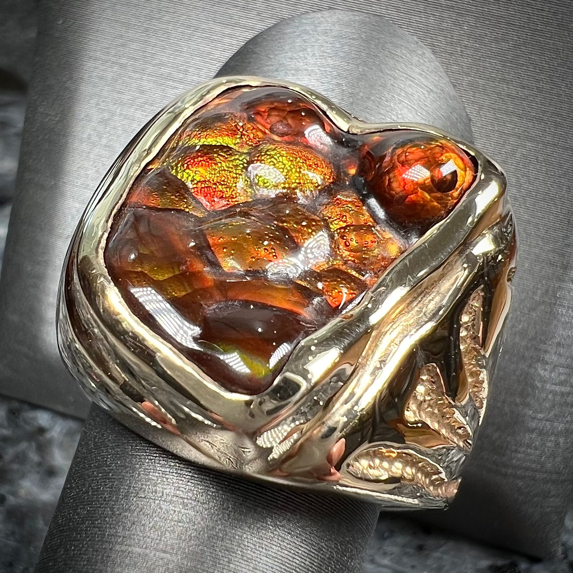 A men's custom fire agate solitaire ring cast in yellow gold.